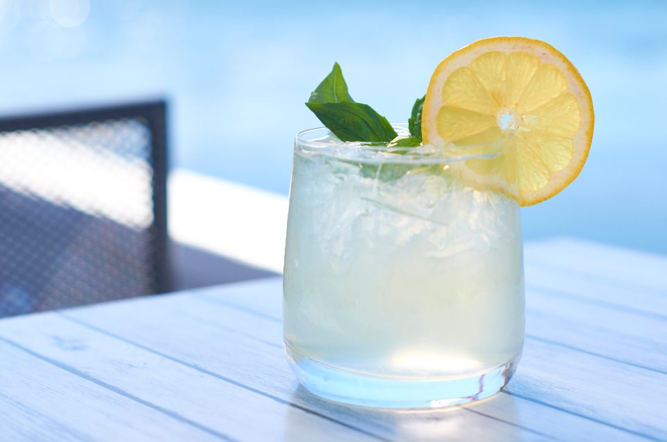 A glass of house lemonade garnished with citrus